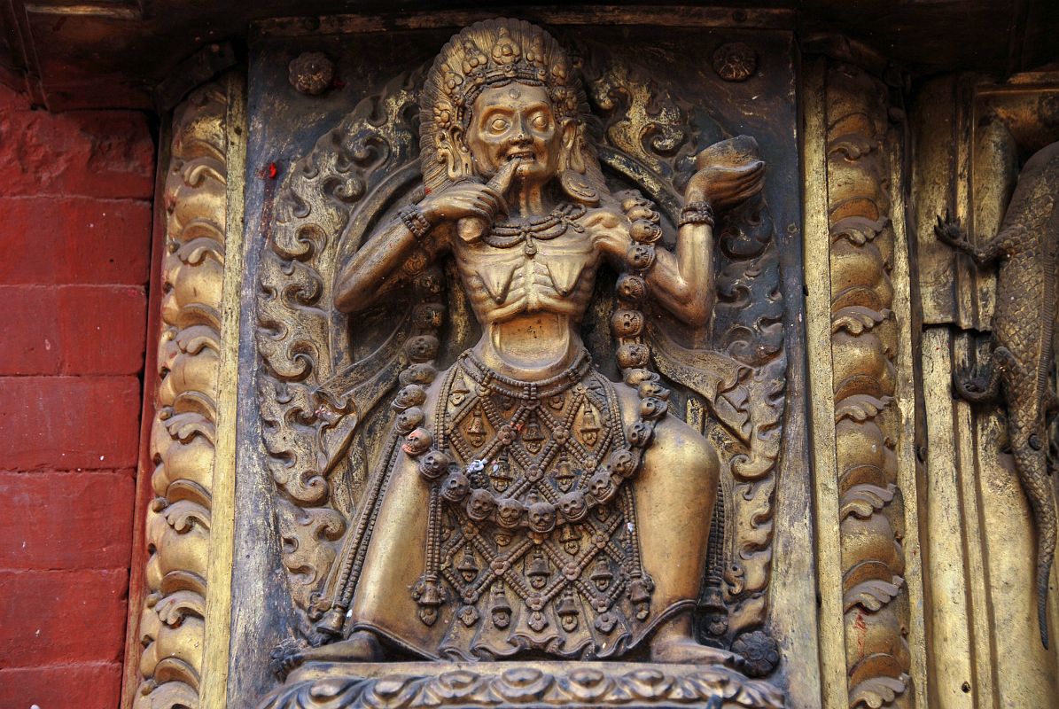 Kathmandu Bhaktapur 04-4 Bhaktapur Durbar Square Golden Gate Emaciated Deity Close Up An emaciated tantric deity flanks the door of the Golden Gate in Bhaktapurs Durbar Square.